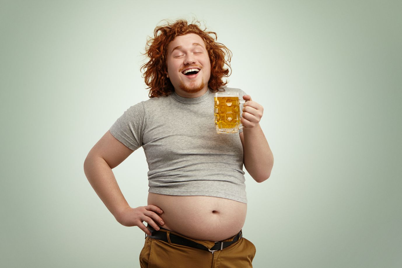 happy-joyful-young-overweight-man-with-curly-red-head-closing-eyes-in-enjoyment2